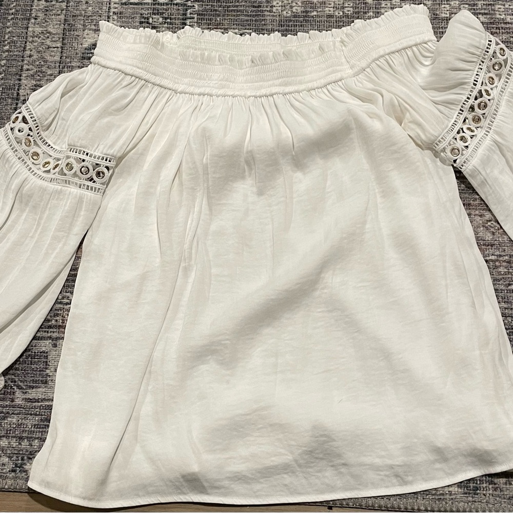 Jennifer Lopez white off shoulder with 3/4” length flared sleeves